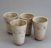 Four khaki ceramic tumblers with nature design